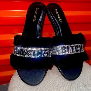 Black flats with the words 100% that Bi*ch on them.